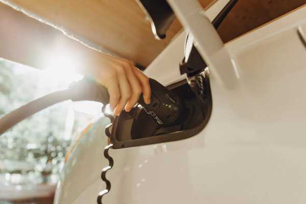Ein E-Auto, in das ein Ladekabel gesteckt wird